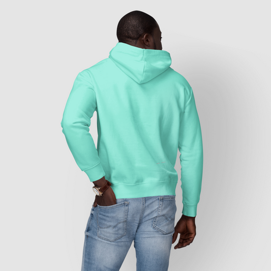 Person wearing a mint hoodie and jeans on a white background