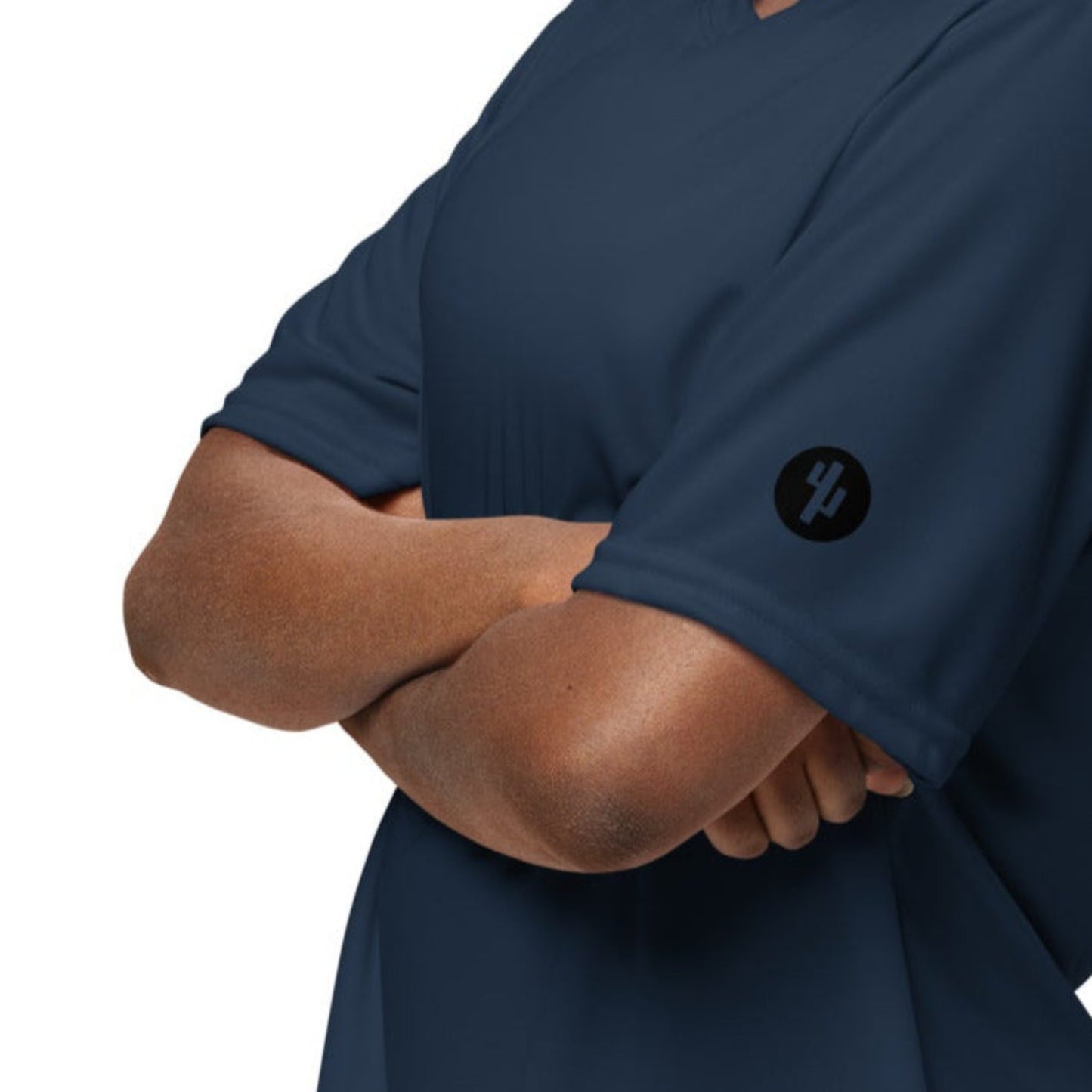 Person wearing a navy blue scrub top on a white background