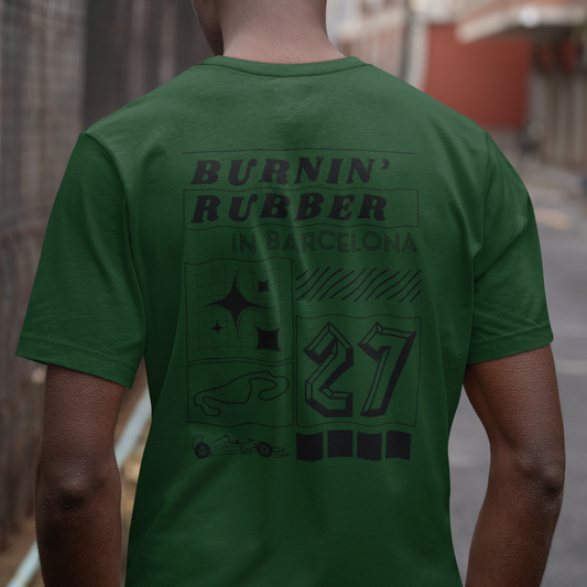 Person wearing a green t-shirt with text and graphics on the back, standing outdoors.