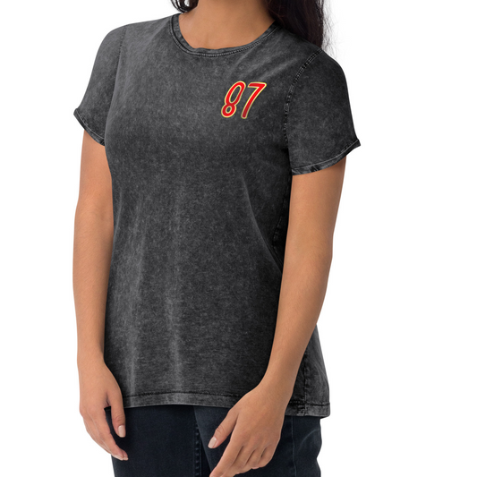 Person wearing a black t-shirt with the number 87 on a white background
