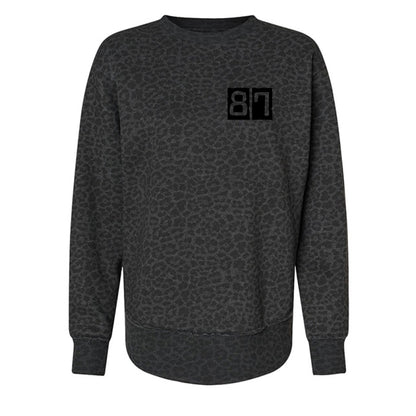 Dark gray patterned sweatshirt with a black logo on a white background