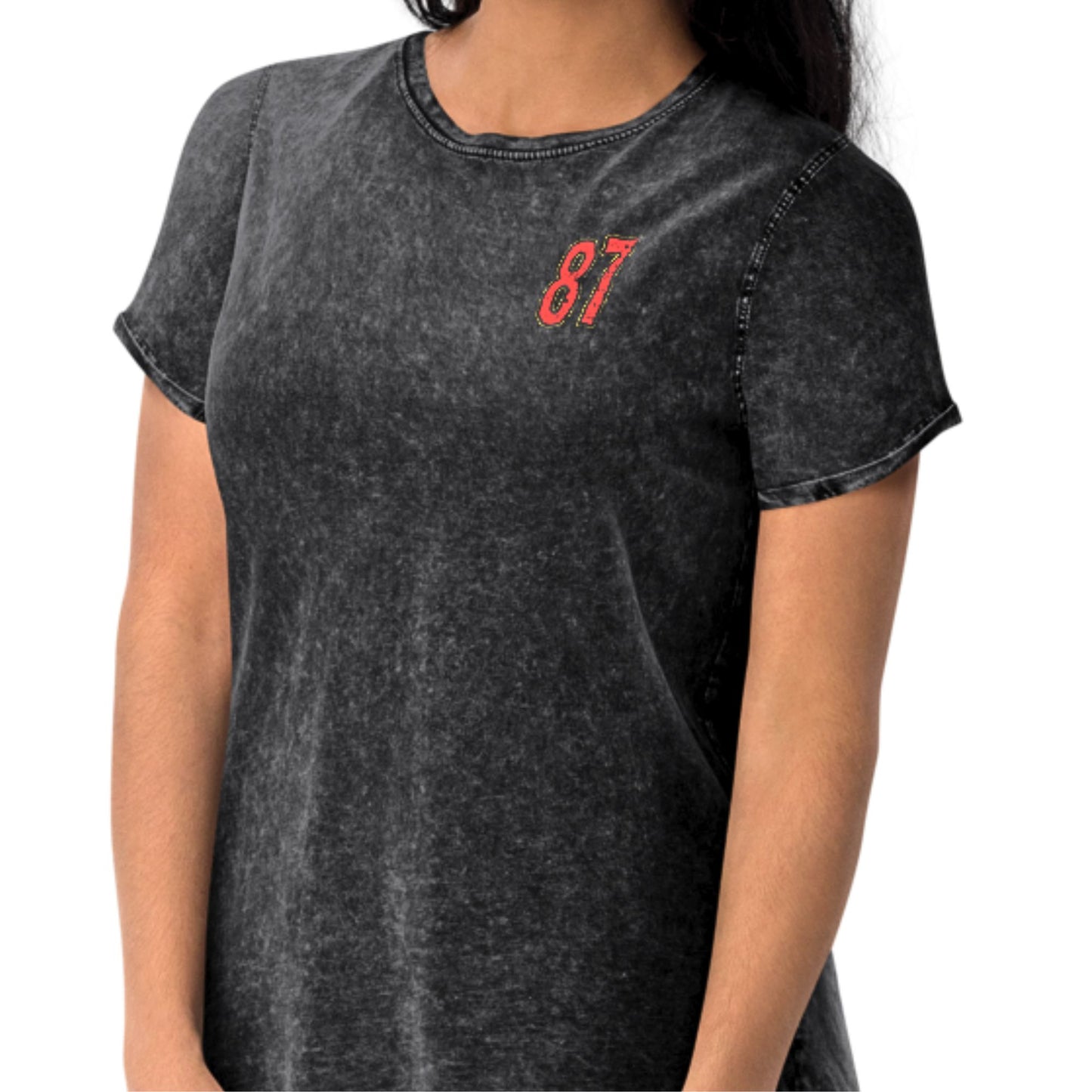 Person wearing a black t-shirt with red number 87 on a white background