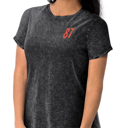 Person wearing a black t-shirt with red number 87 on a white background