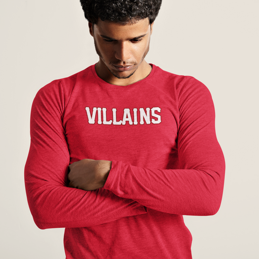Man wearing a red long-sleeve shirt with 'VILLAINS' text on a beige background