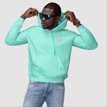 Man wearing a light blue hoodie and sunglasses on a plain background