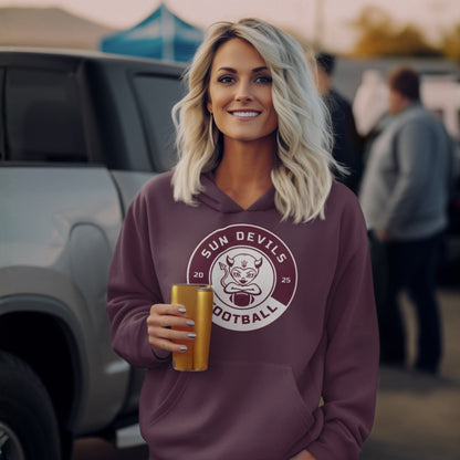 Woman wearing a maroon hoodie with a 'Sun Devils Football' logo, holding a drink, standing in a casual outdoor setting.