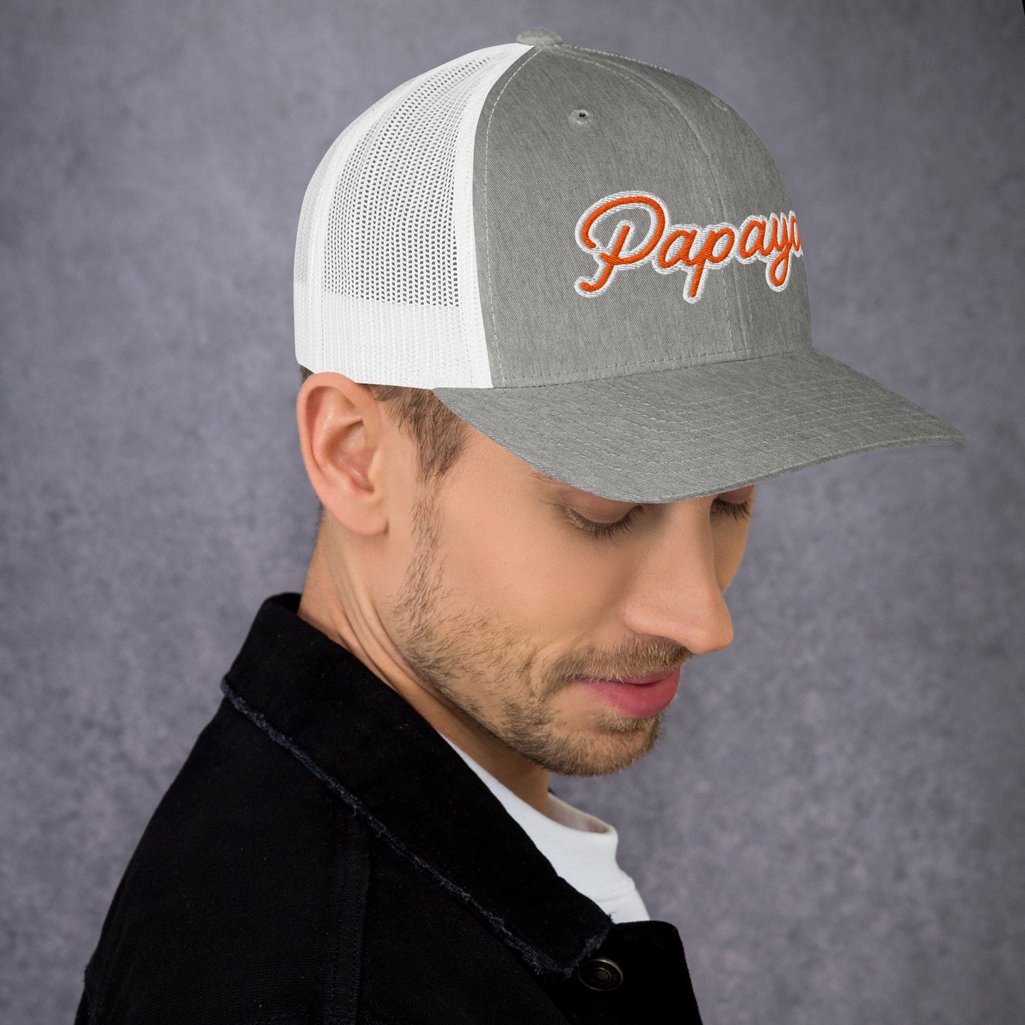 Man wearing a gray and white cap with 'Papaya' logo on a gray background
