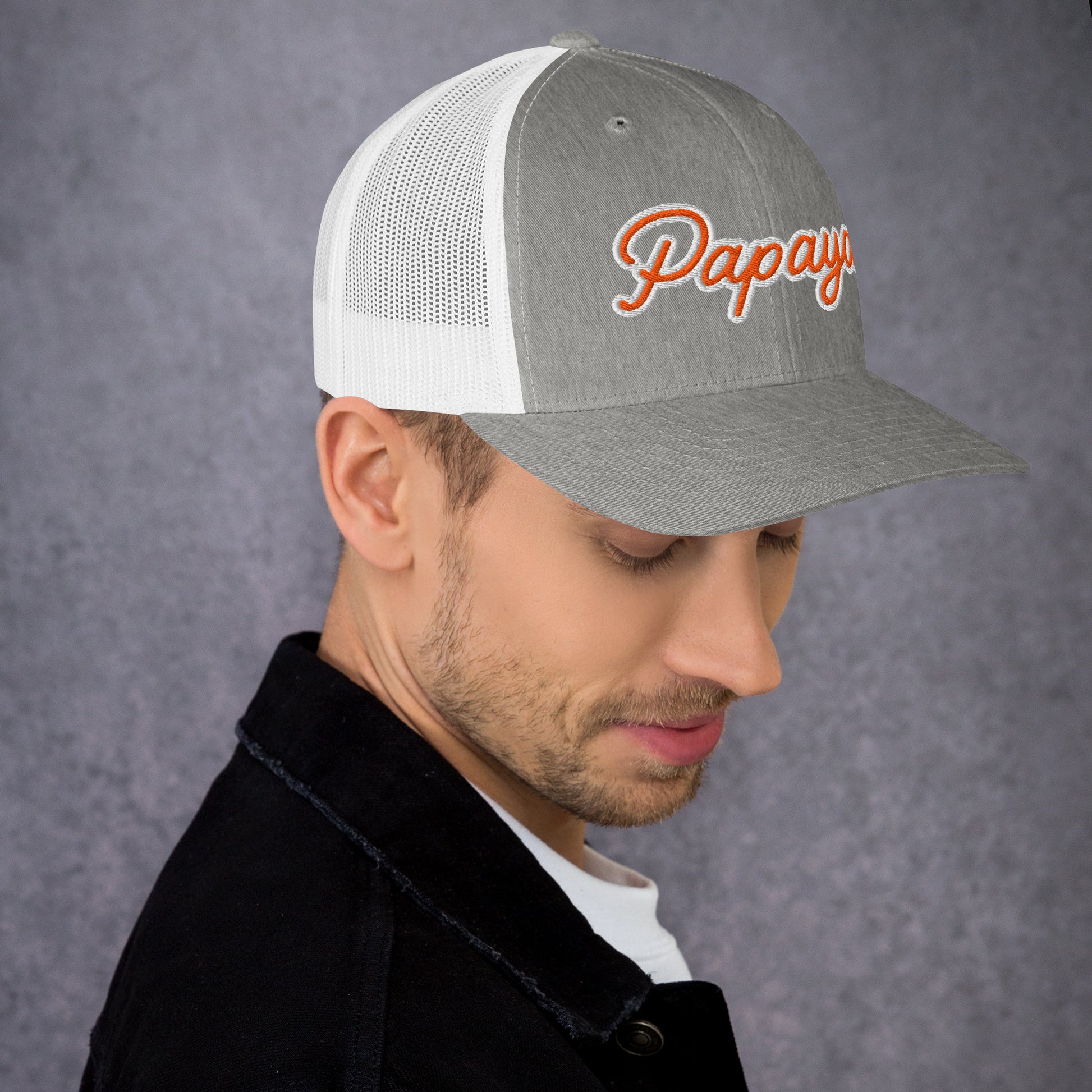 Man wearing a gray and white cap with 'Papaya' logo on a gray background