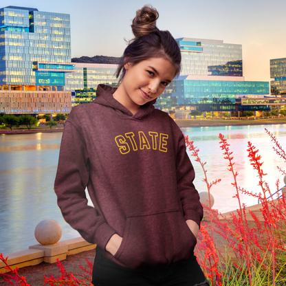 Person wearing a maroon hoodie with 'STATE' text in front of a cityscape.