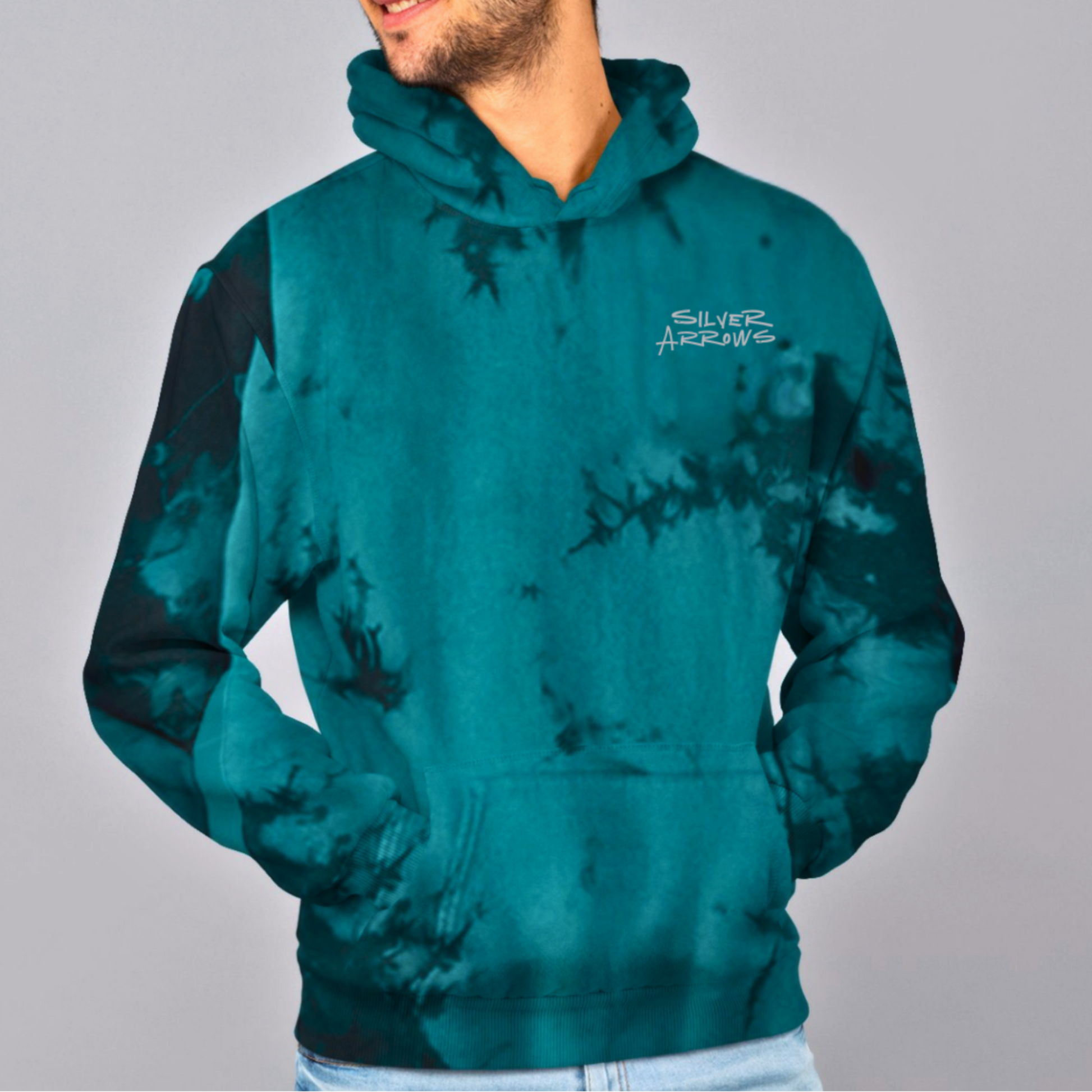 Man wearing a teal tie-dye hoodie with a logo on a gray background