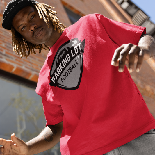 Person wearing a red t-shirt with a 'Parking Lot Football' graphic.