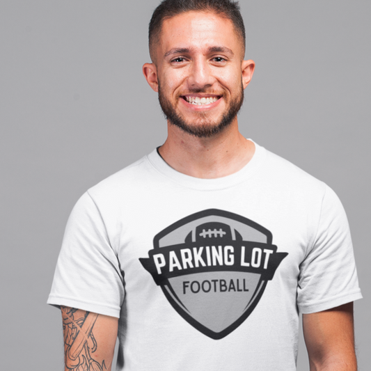 Man wearing a white t-shirt with 'Parking Lot Football' design on a gray background